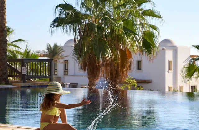Child playing by the swimming pool at Ancient Sands Golf Resort El Gouna