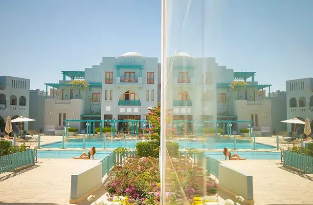 A woman sitting by the pool, enjoying the sun at Fanadir el Gouna.