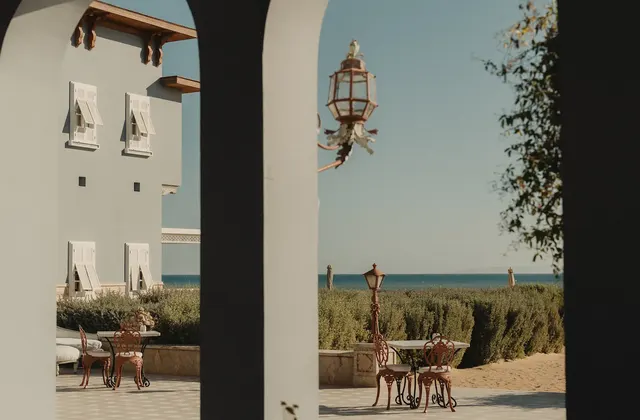 Arched terrace with café tables at La Maison Bleue El Gouna overlooking the Red Sea.