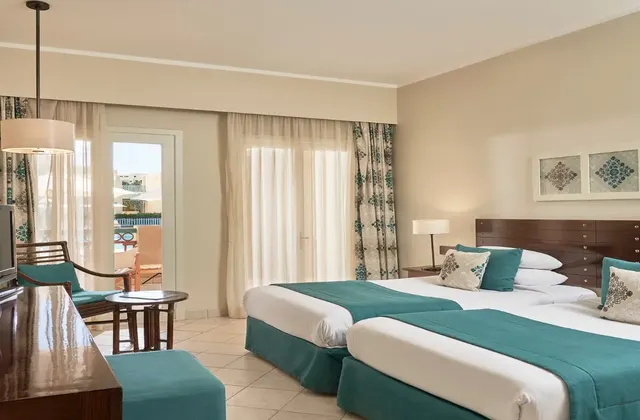 A twin room at Mosaique Hotel, featuring modern amenities and comfortable furnishings.