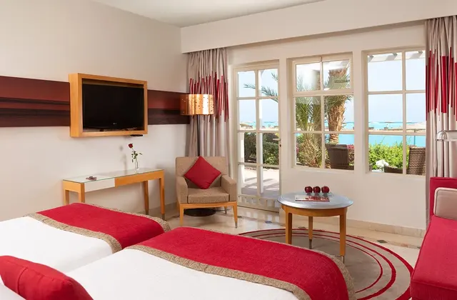 Twin bed with curtains open in a cozy hotel room, inviting guests to relax after a long day of exploring.