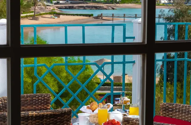 Breakfast served on a balcony with a view, featuring a spread of delicious food and beverages.
