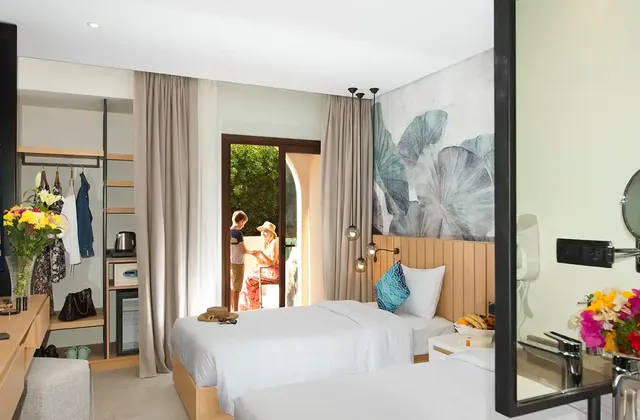 Twin room with an open terrace, where a mom is talking to her son outside. The room features two comfortable beds, and the terrace provides a charming outdoor space with a view.