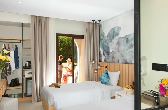 win room with an open terrace, where a mom is talking to her son outside. The room features two comfortable beds, and the terrace provides a charming outdoor space with a view.